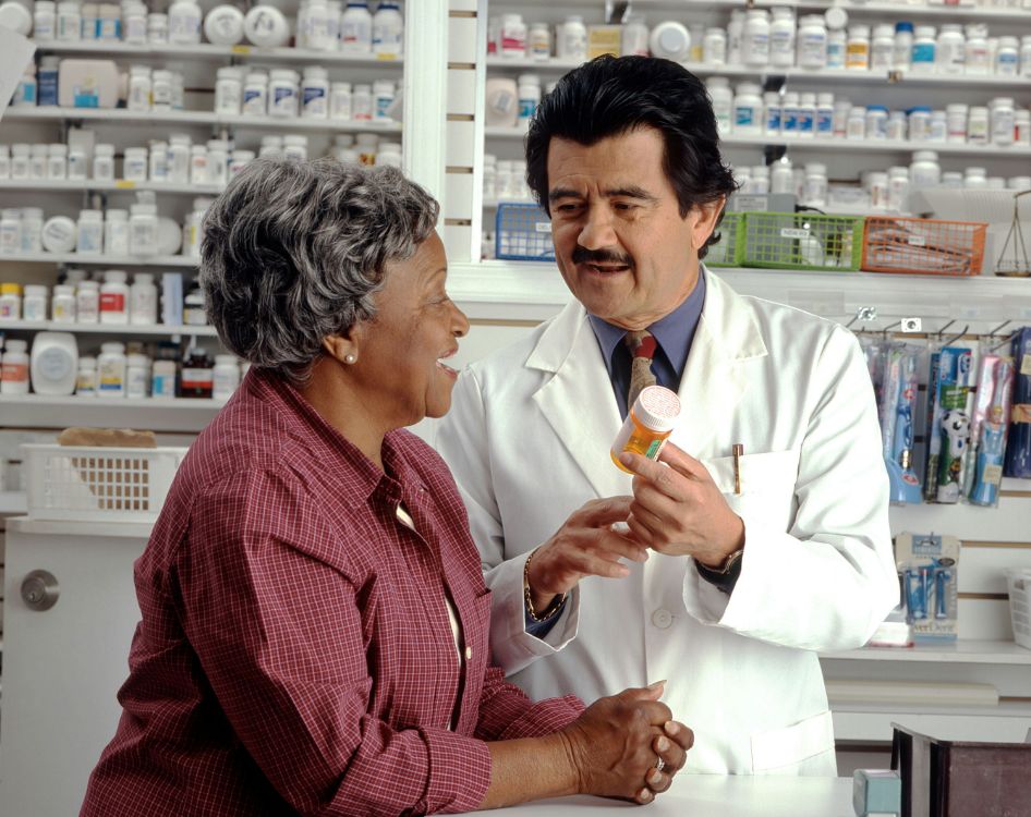 Male pharmacist helping a customer