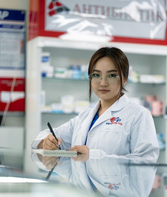 female pharmacist writing notes